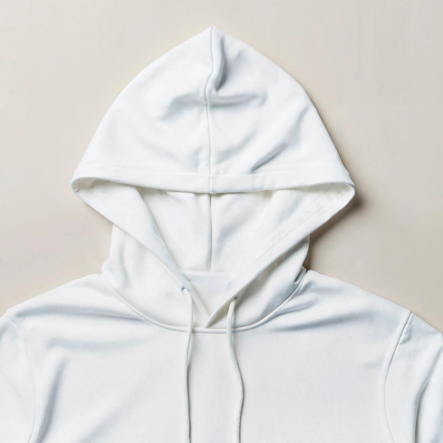White hoodie on a beige background