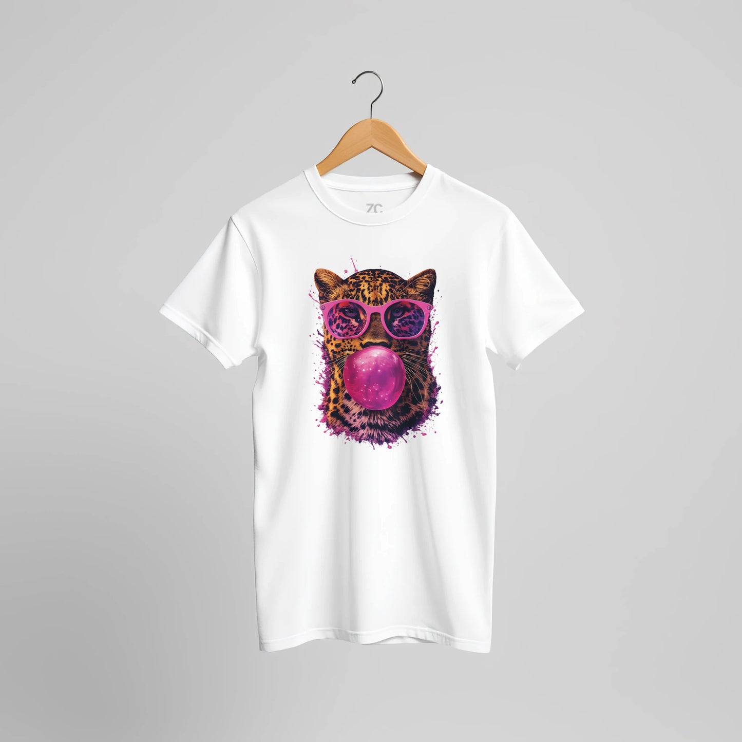 White t-shirt with a colorful cat graphic wearing sunglasses and blowing a bubble on a gray background.