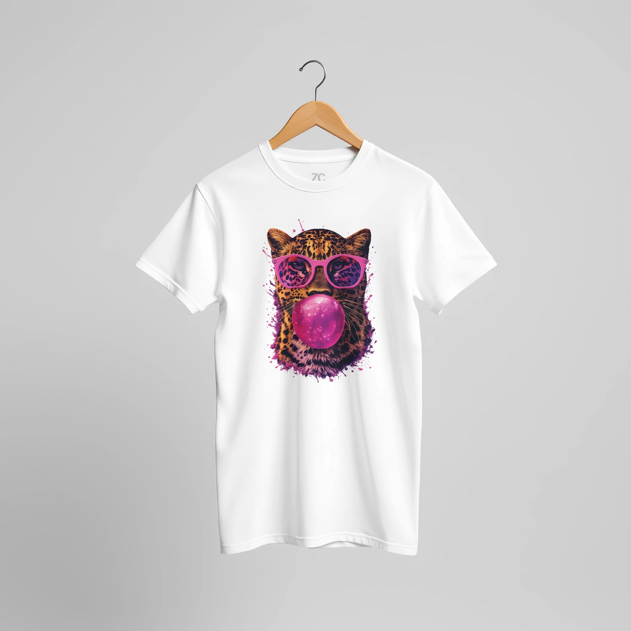 White t-shirt with a colorful cat graphic wearing sunglasses and blowing a bubble on a gray background.