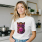 Woman wearing a white t-shirt with a colorful cat graphic in a kitchen.